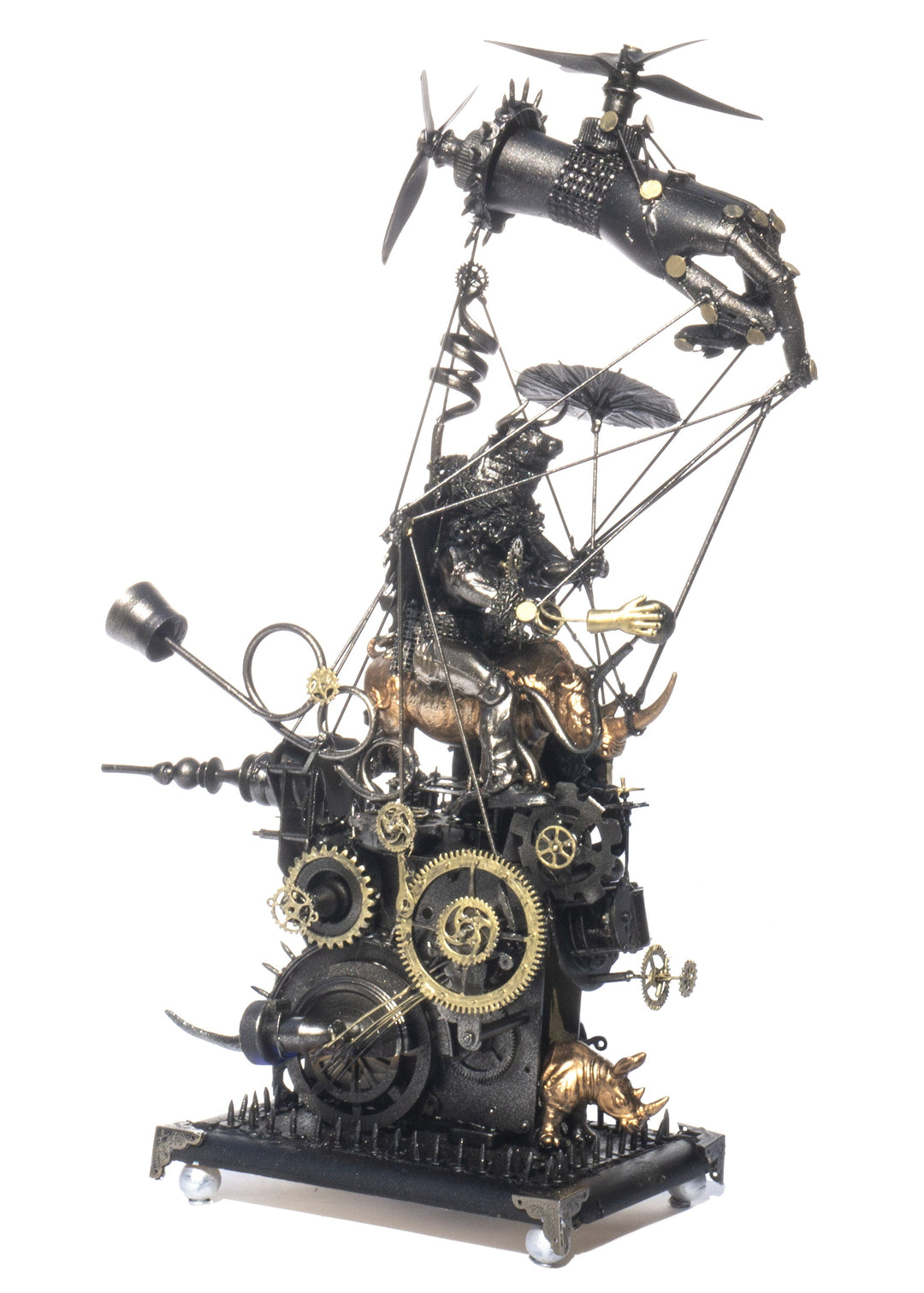 “Minotaur’s Homage to Dürer” by Andrew Stevens – a one-off steampunk sculpture created from recycled toys, metal, and engine parts. Features a winged Minotaur atop mechanical gears and bronze figures, finished in dark patina with fine industrial detail.