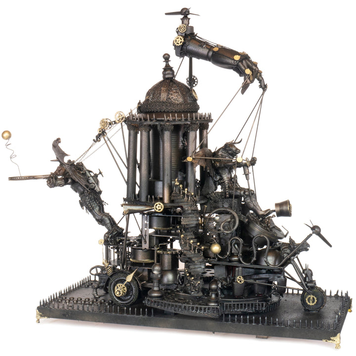 “Minotaurs’ Mobile Home” by Andrew Stevens – a one-off steampunk sculpture crafted from recycled metal, toys and wood. Featuring winged Minotaur figures amid gears and domed structures, finished in dark bronze patina with intricate mechanical detail.