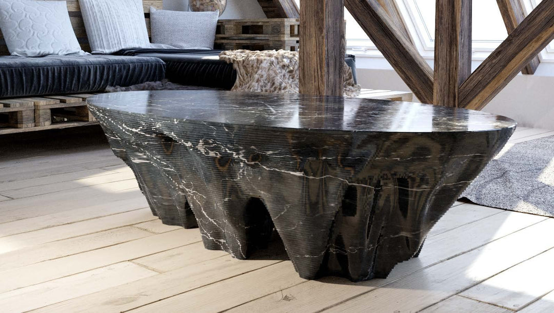 Duffy London Monument Valley Dining Table carved from marble with sculptural canyon-like base and glass top, inspired by natural rock formations.
