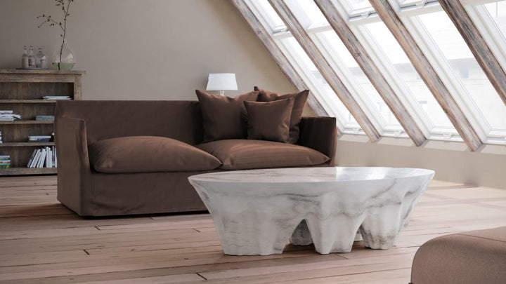 Duffy London Monument Valley Dining Table carved from marble with sculptural canyon-like base and glass top, inspired by natural rock formations.