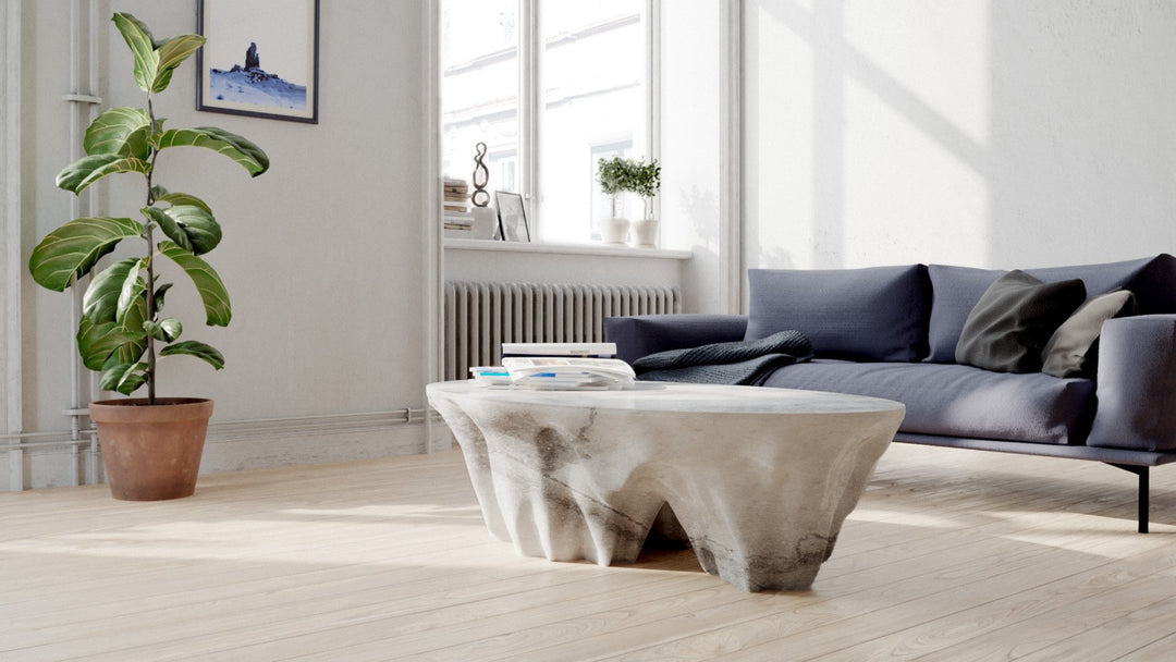 Duffy London Monument Valley Dining Table carved from marble with sculptural canyon-like base and glass top, inspired by natural rock formations.