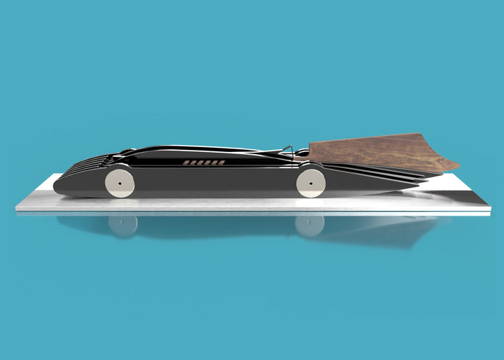 Limited-edition Bluebird V 1935 sculpture by Jonny Ambrose — layered black polished acrylic body with walnut tail-fin and polished nickel-plated aluminium details on a sleek white acrylic or brushed aluminium plinth, celebrating Malcolm Campbell’s 1935 land speed record at Bonneville Salt Flats.