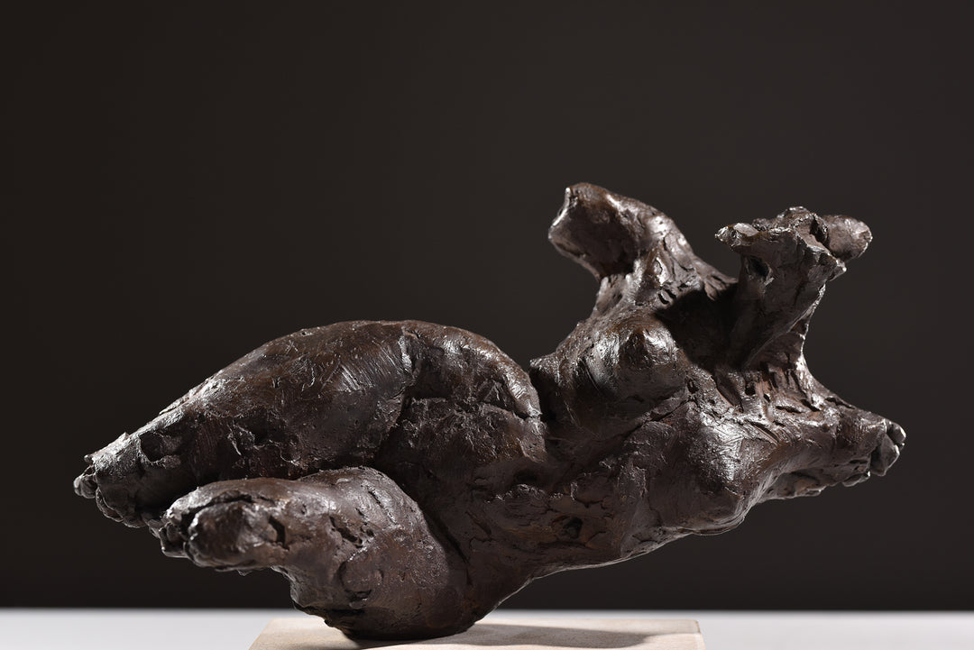 ‘Nude Emergence Torso’ by Hamish Mackie, a limited-edition contemporary bronze figurative sculpture depicting a fragmented reclining female nude torso. Inspired by ancient sculptural artefacts, the abstracted human form features rough, expressive modelling, weathered surfaces and an earthy brown bronze patina. Mounted horizontally on a rectangular Ancaster Weatherbed stone plinth, the sculpture explores the natural beauty and tactile qualities of the female form.