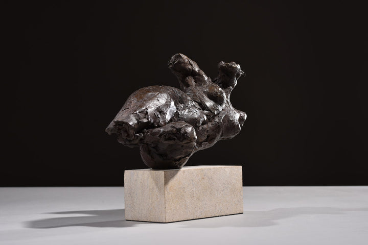 ‘Nude Emergence Torso’ by Hamish Mackie, a limited-edition contemporary bronze figurative sculpture depicting a fragmented reclining female nude torso. Inspired by ancient sculptural artefacts, the abstracted human form features rough, expressive modelling, weathered surfaces and an earthy brown bronze patina. Mounted horizontally on a rectangular Ancaster Weatherbed stone plinth, the sculpture explores the natural beauty and tactile qualities of the female form.