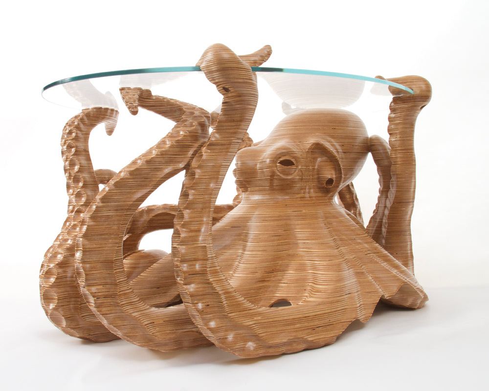 Hand-carved birch plywood octopus coffee table by Bill Prickett with sculptural tentacles supporting a low iron toughened glass top, combining functional furniture with detailed contemporary wood sculpture.