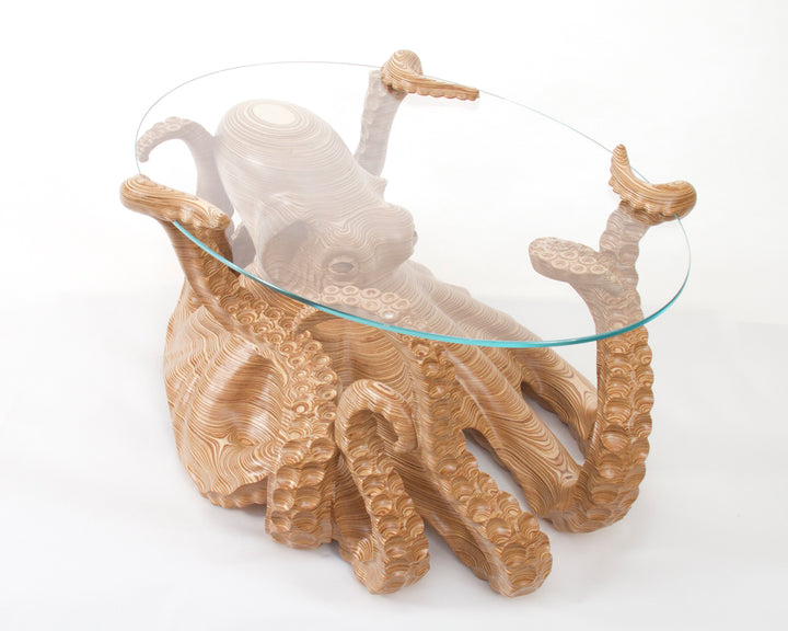 Hand-carved birch plywood octopus coffee table by Bill Prickett with sculptural tentacles supporting a low iron toughened glass top, combining functional furniture with detailed contemporary wood sculpture.