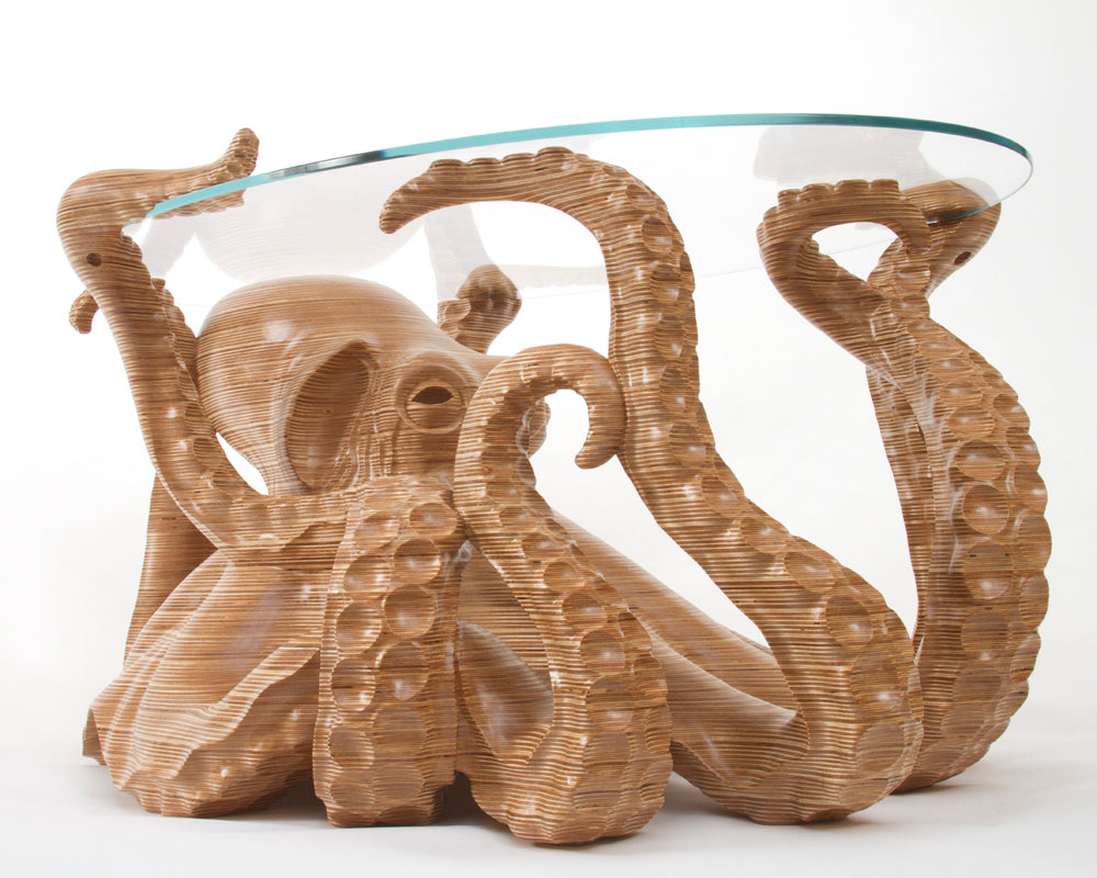 Hand-carved birch plywood octopus coffee table by Bill Prickett with sculptural tentacles supporting a low iron toughened glass top, combining functional furniture with detailed contemporary wood sculpture.