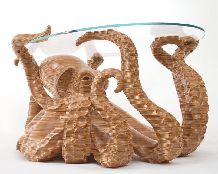 Hand-carved birch plywood octopus coffee table by Bill Prickett with sculptural tentacles supporting a low iron toughened glass top, combining functional furniture with detailed contemporary wood sculpture.