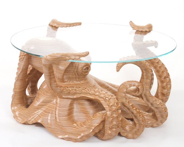 Hand-carved birch plywood octopus coffee table by Bill Prickett with sculptural tentacles supporting a low iron toughened glass top, combining functional furniture with detailed contemporary wood sculpture.