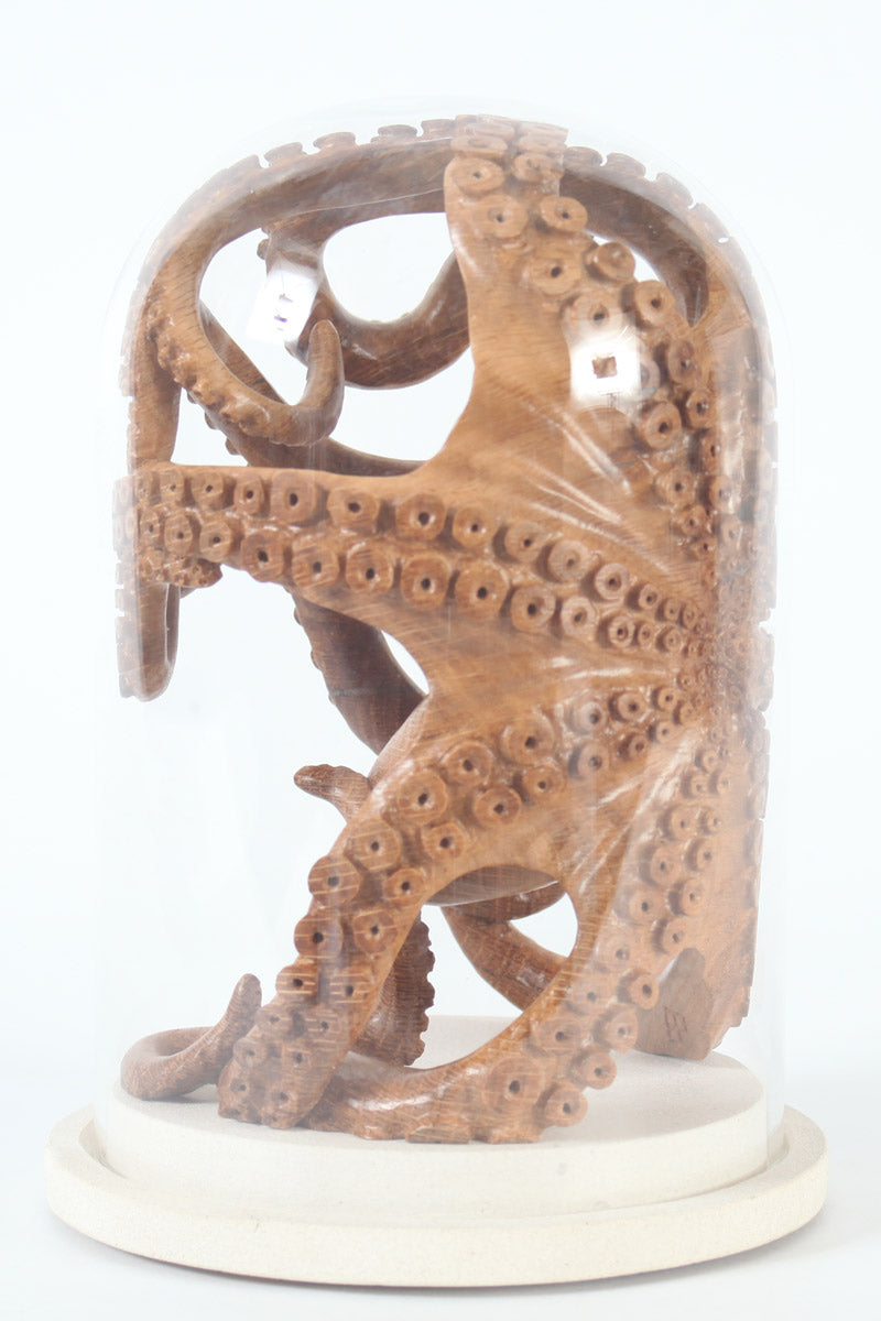 Hand-carved wooden octopus sculpture by Bill Prickett, carved from English oak burr and enclosed within a clear glass dome, its detailed tentacles pressed against the curved surface and mounted on a Portland stone base.
