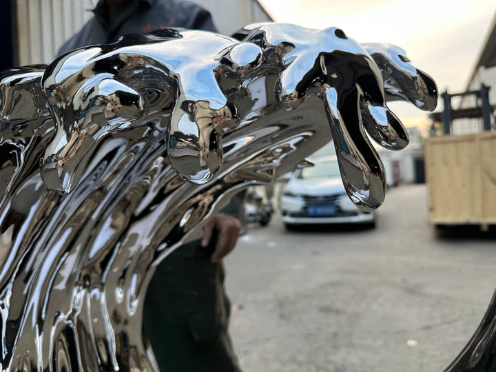 Striking wall-mounted sculpture by Yoni Alter, crafted from mirror-polished stainless steel and shaped into a stylised cresting wave. The reflective surface and sweeping fluid lines capture movement, energy, and elegance, blending natural inspiration with futuristic minimalism. Suitable for both interior and exterior display.