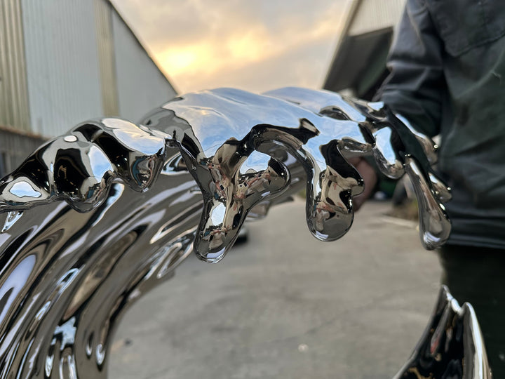 Striking wall-mounted sculpture by Yoni Alter, crafted from mirror-polished stainless steel and shaped into a stylised cresting wave. The reflective surface and sweeping fluid lines capture movement, energy, and elegance, blending natural inspiration with futuristic minimalism. Suitable for both interior and exterior display.