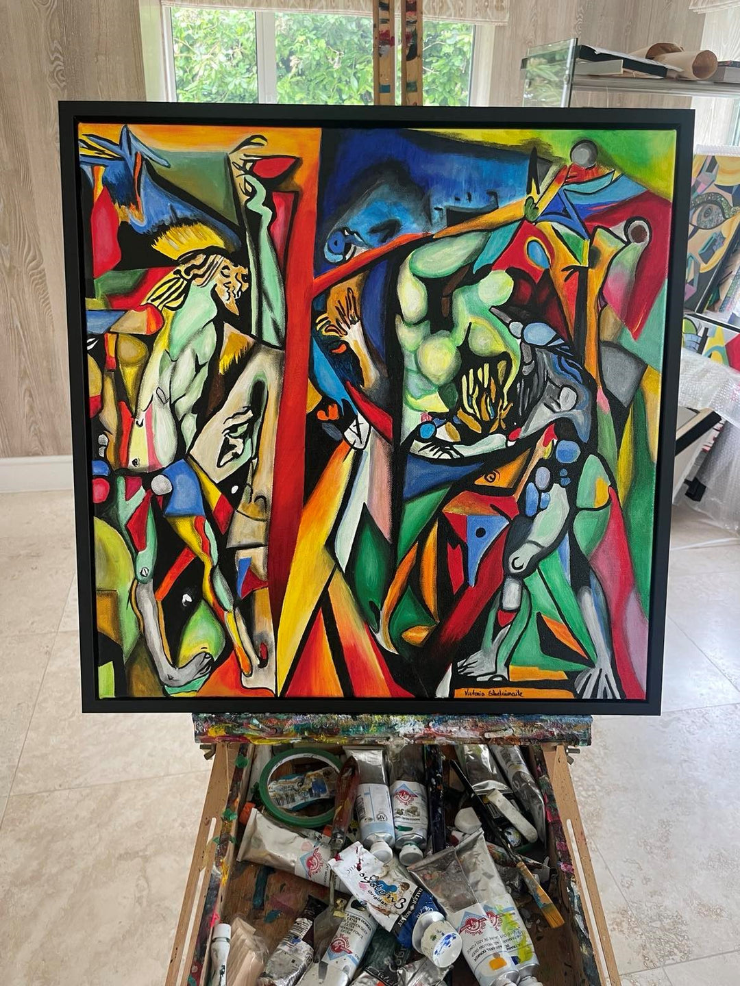 Vibrant abstract painting with intertwined human figures, bold colours, and fragmented geometric shapes in a surreal composition.