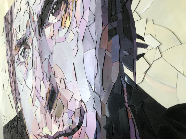 Ed Chapman mosaic portrait of Paul Weller created from broken vinyl records, with layered fragments in pale lilac, cream, and soft pink tones forming a striking likeness of the British music icon.