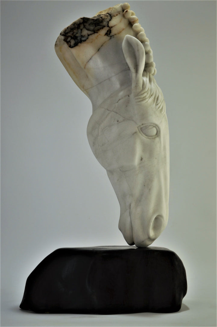 Deborah Harrison sculpture Palomo, a one-off hand-carved horse head in rainbow alabaster with intricate mane detail and a natural crown of rounded alabaster spheres, mounted on a dark soapstone base. The alabaster reveals soft white, ivory, cream and golden brown tones with darker natural veining, blending realism with symbolic form.