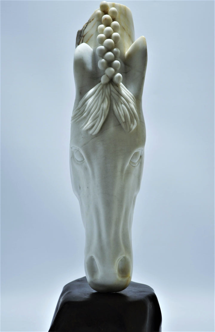Deborah Harrison sculpture Palomo, a one-off hand-carved horse head in rainbow alabaster with intricate mane detail and a natural crown of rounded alabaster spheres, mounted on a dark soapstone base. The alabaster reveals soft white, ivory, cream and golden brown tones with darker natural veining, blending realism with symbolic form.