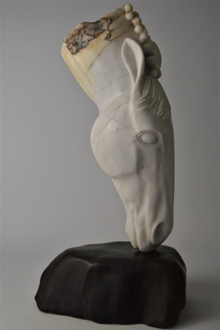 Deborah Harrison sculpture Palomo, a one-off hand-carved horse head in rainbow alabaster with intricate mane detail and a natural crown of rounded alabaster spheres, mounted on a dark soapstone base. The alabaster reveals soft white, ivory, cream and golden brown tones with darker natural veining, blending realism with symbolic form.