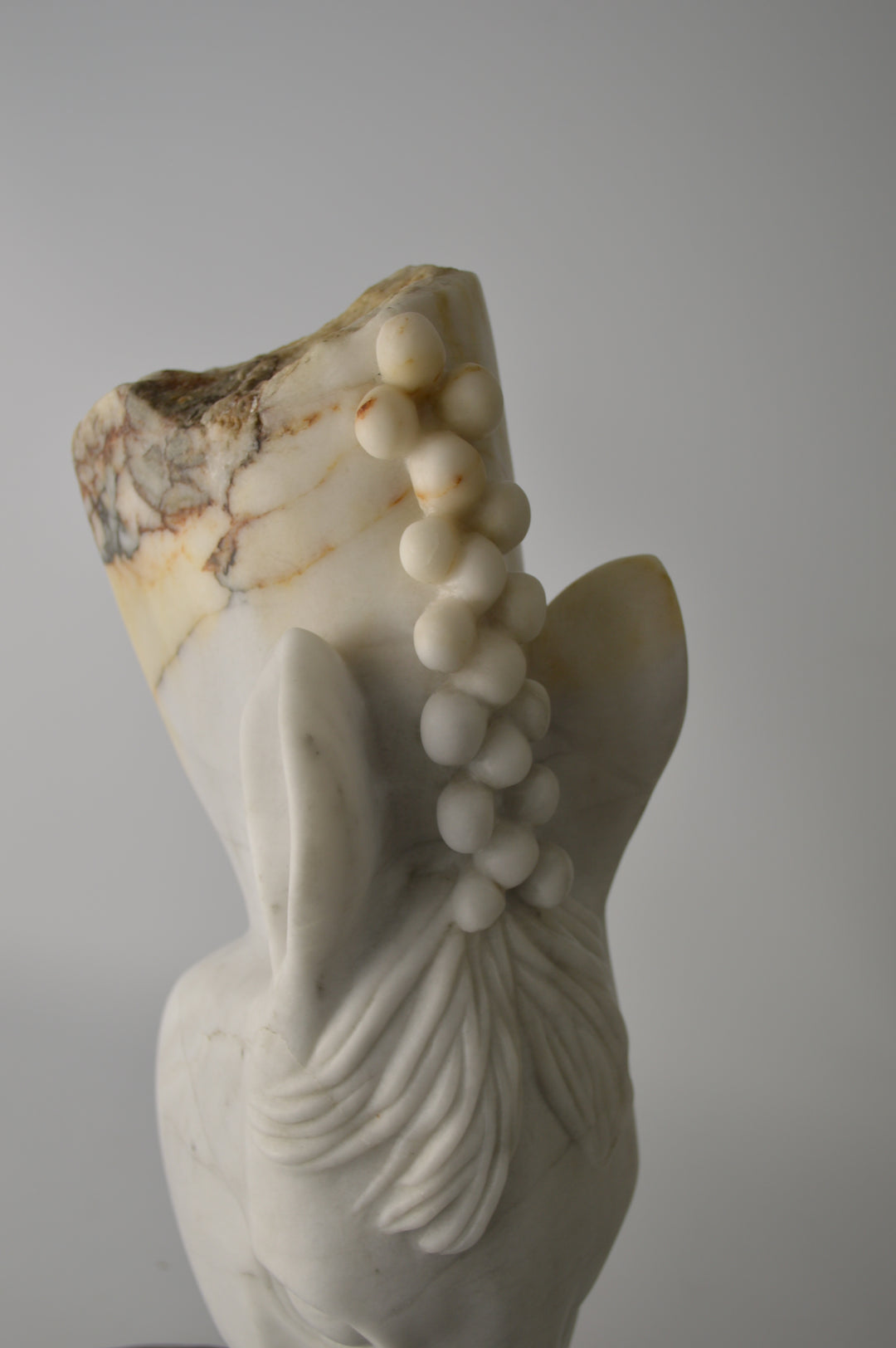 Deborah Harrison sculpture Palomo, a one-off hand-carved horse head in rainbow alabaster with intricate mane detail and a natural crown of rounded alabaster spheres, mounted on a dark soapstone base. The alabaster reveals soft white, ivory, cream and golden brown tones with darker natural veining, blending realism with symbolic form.