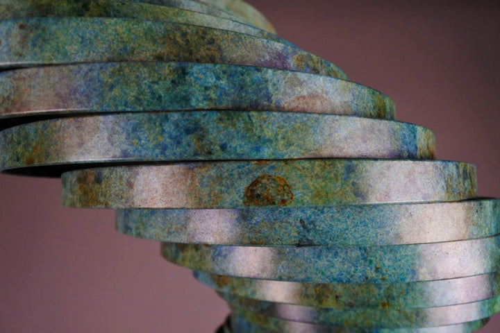 Vortex II by Thomas Joynes – a limited edition bronze sculpture with artisan patina, exploring Fibonacci-based forms through stacked, spiralling discs. The rich verdigris patina in green-blue and rust tones highlights the rhythmic, wave-like movement of the bronze layers. Mounted on a smooth Carrara marble base, the piece brings a sense of elegance and kinetic energy to any contemporary interior.