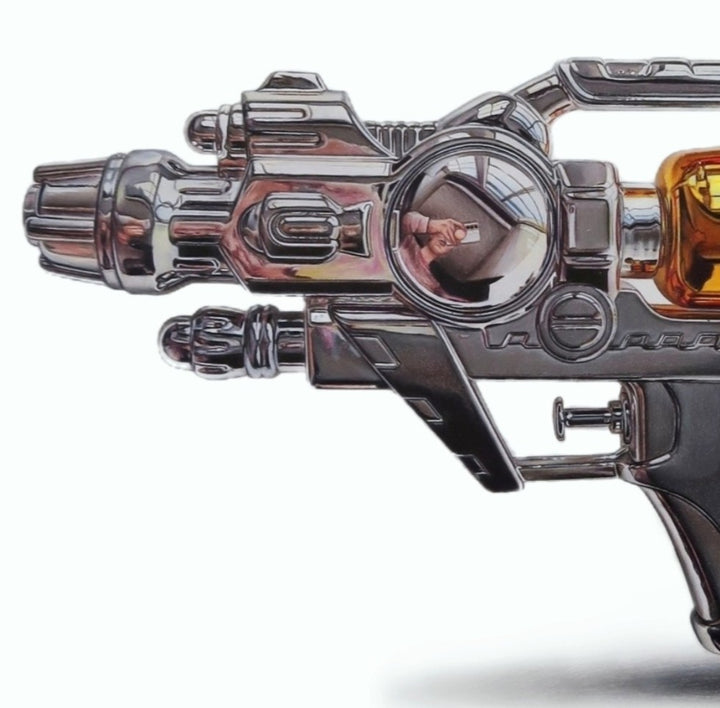 Hyper-realistic coloured pencil drawing of a futuristic ray gun with chrome detailing and gold cartridge, rendered with extreme precision by Hannah Lipsey