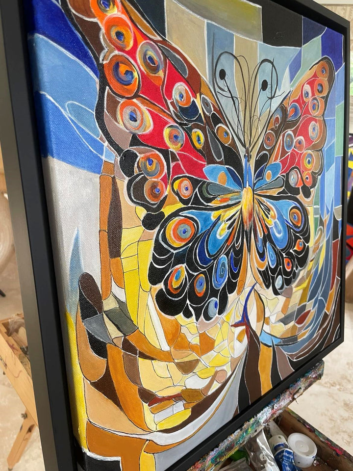 Abstract painting of a vibrant butterfly with patterned wings in red, blue, and orange tones, set against a mosaic-style background.

