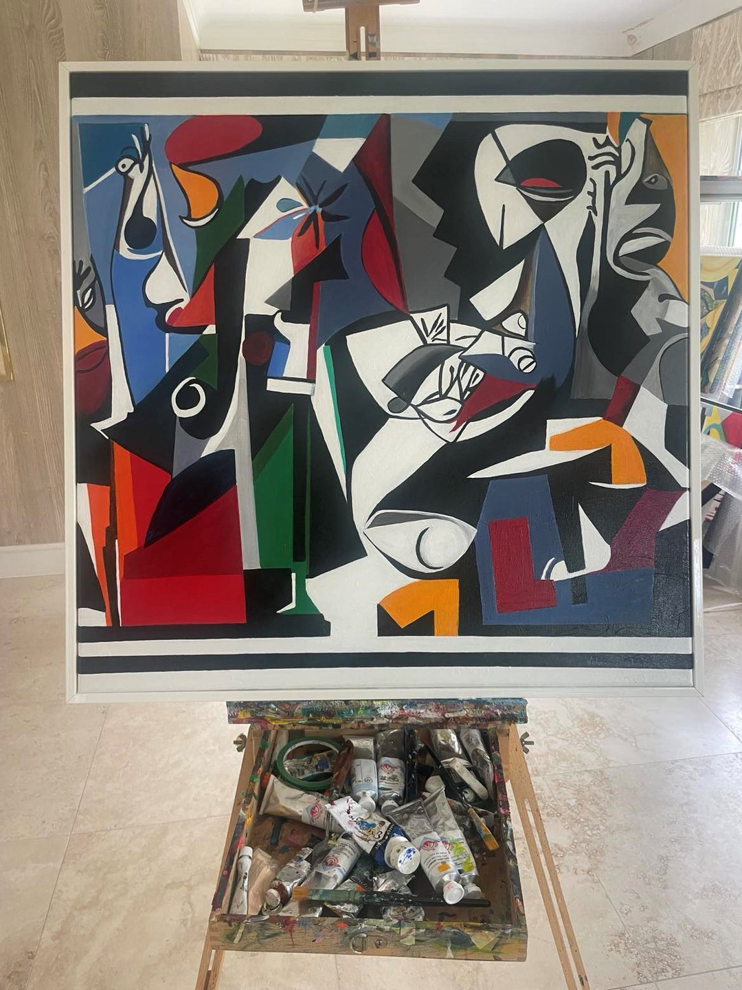 Bold abstract painting with fragmented faces, vivid geometric shapes, and a dramatic palette of red, black, blue, and green.
