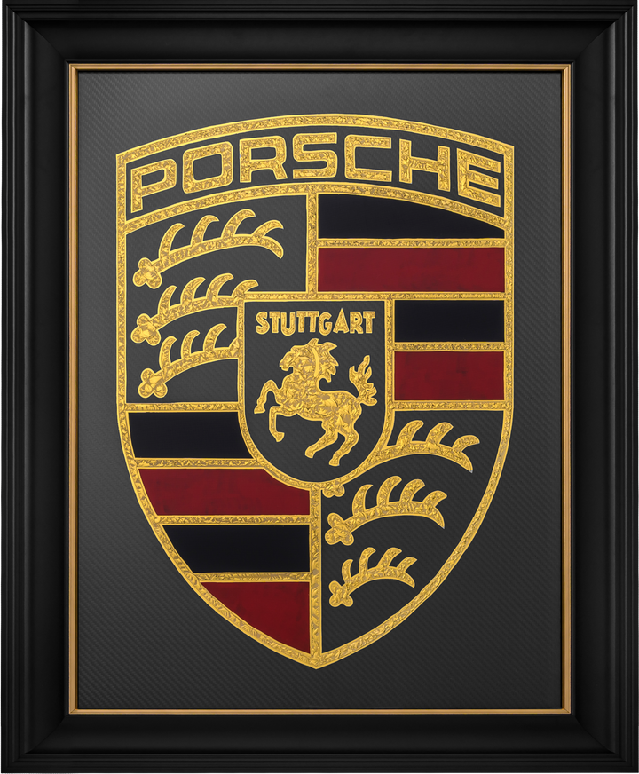 ‘Stuttgart Carbon’ by Vince Edmunds, a handcrafted Porsche automotive artwork featuring the iconic Porsche Stuttgart crest recreated in genuine 24-carat gold leaf and glue-chipped glass. The detailed shield incorporates the prancing Stuttgart horse, ornate gold antlers and lettering, and deep red and black sections against a dark grey carbon fibre background with a visible diagonal weave. Presented in a satin black frame with a fine gold sight line, combining traditional glass gilding with modern motorsport