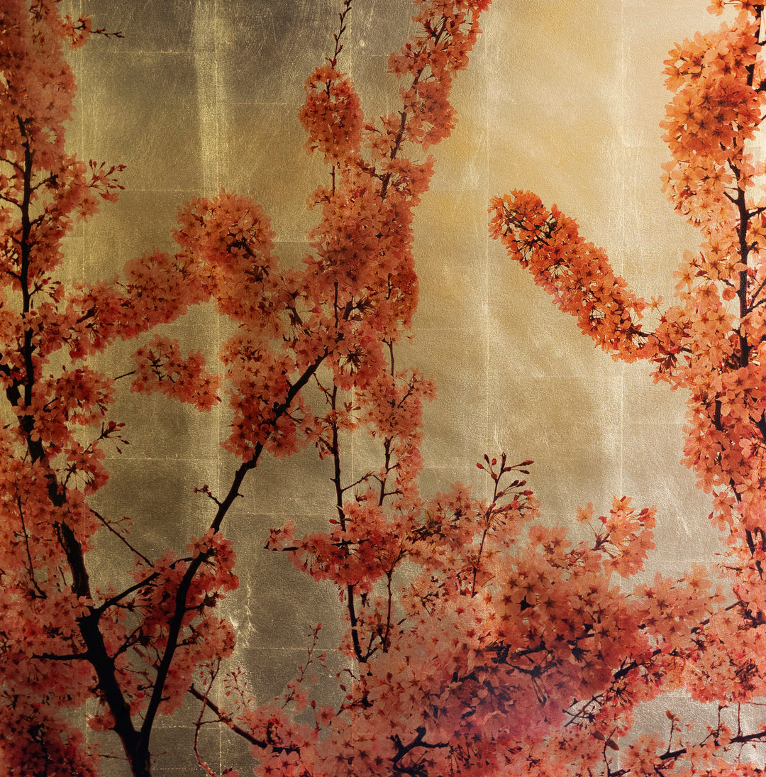 Robert Pereira Hind’s Prunus Sakura III — a radiant mixed media artwork depicting vivid orange-red cherry blossom branches against a shimmering gold-leaf background. Created with acrylic paint and organic photographic pigment on a gilded wooden panel, the composition glows with warmth and depth. Finished with shellac and art glazes, the piece will gently oxidise over time, developing a subtle patina that adds atmosphere and timeless character.