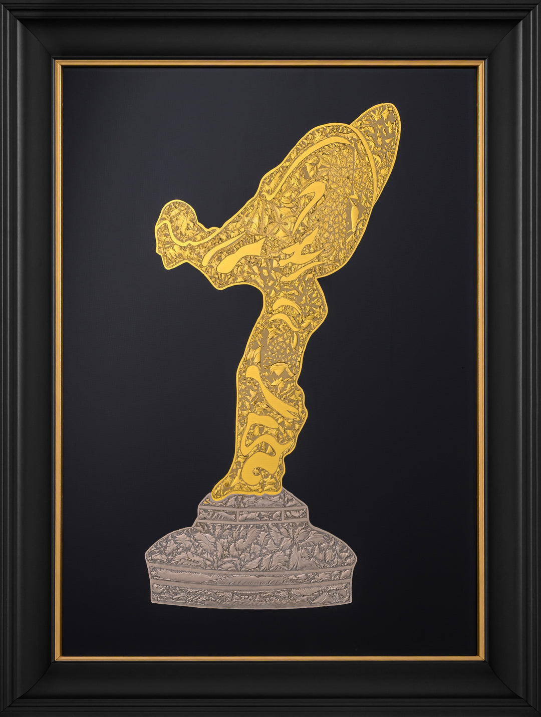 ‘Golden Spirit’ by Vince Edmunds, a handcrafted Rolls-Royce automotive artwork depicting the iconic Spirit of Ecstasy bonnet mascot in genuine 24-carat gold leaf and 22.5-carat champagne gold leaf on glue-chipped glass. The flowing, wing-like figure features intricate crystalline gold textures, rising from an ornate champagne-gold pedestal against a deep black background. Presented in a satin black frame with a fine gold sight line, celebrating the historic Rolls-Royce Flying Lady emblem.