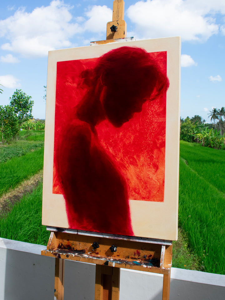 Oil on canvas painting by Dan Bullock, titled Radiance. A striking silhouette portrait of a woman in profile, painted entirely in deep crimson red within a bold rectangular frame, set against a neutral canvas ground. The figure’s bowed head and soft edges evoke intimacy and contemplation, with rich tonal depth and glowing intensity.