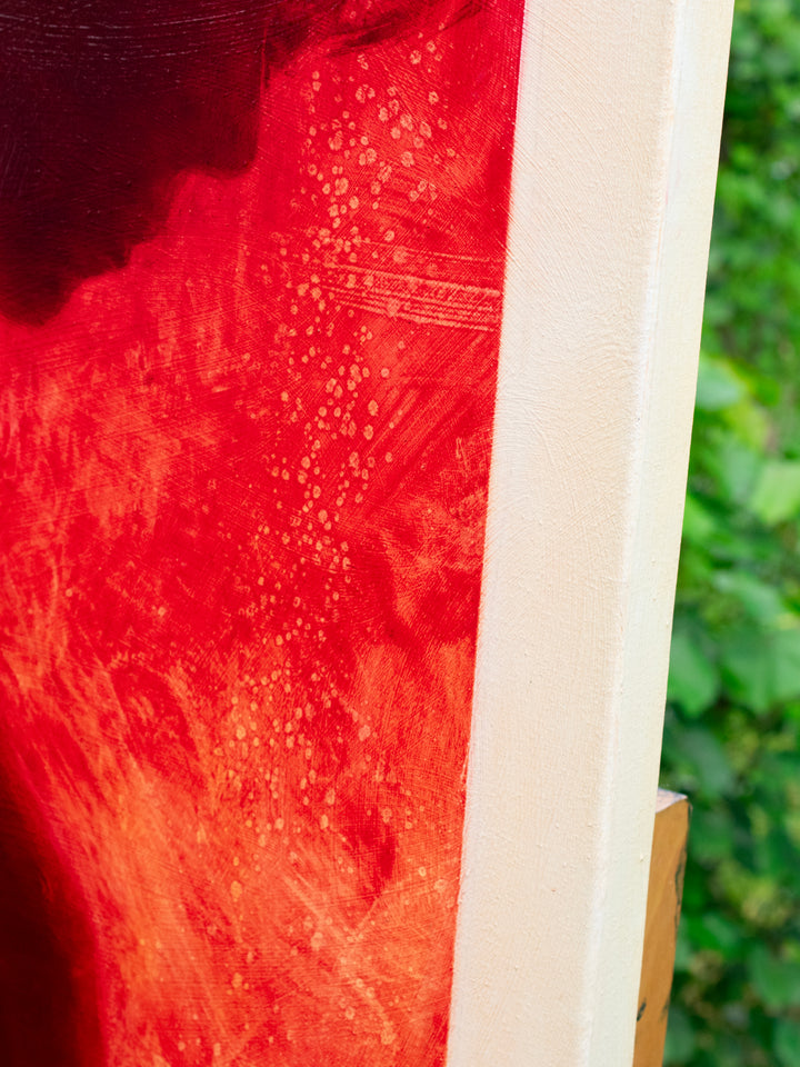 Oil on canvas painting by Dan Bullock, titled Radiance. A striking silhouette portrait of a woman in profile, painted entirely in deep crimson red within a bold rectangular frame, set against a neutral canvas ground. The figure’s bowed head and soft edges evoke intimacy and contemplation, with rich tonal depth and glowing intensity.