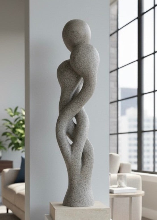 Carved abstract figurative sculpture formed from a single block of Blue and Buff Ancaster Weatherbed stone, with intertwined vertical forms rising from an Ancaster stone plinth, featuring smooth flowing contours, subtle surface texture and balanced proportions designed for indoor display.