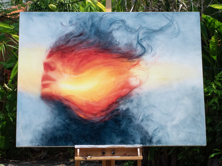 Large oil on canvas painting by Dan Bullock, titled Reverie. A dreamlike portrait of a female face in profile, dissolving into swirling colours of fiery red, orange, and golden yellow, contrasted with cool blue and smoky black tones. The composition radiates energy and motion, blending realism with abstraction.