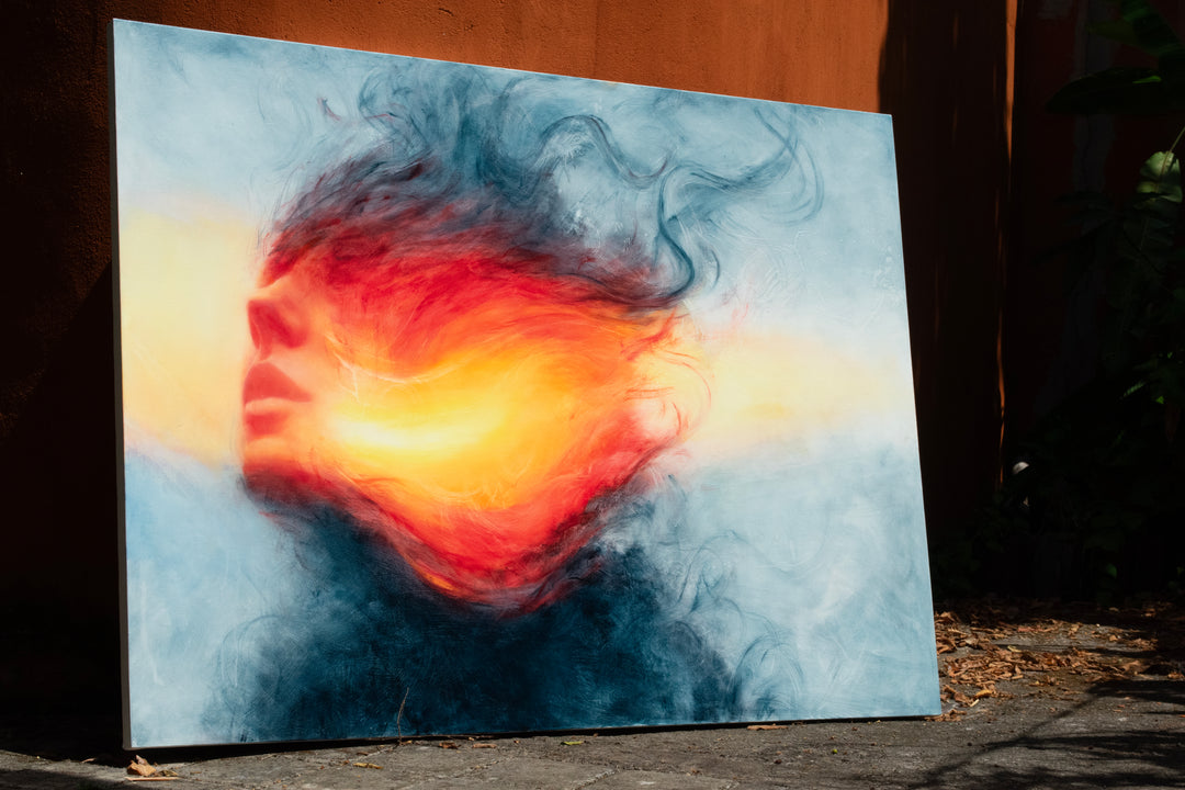 Large oil on canvas painting by Dan Bullock, titled Reverie. A dreamlike portrait of a female face in profile, dissolving into swirling colours of fiery red, orange, and golden yellow, contrasted with cool blue and smoky black tones. The composition radiates energy and motion, blending realism with abstraction.