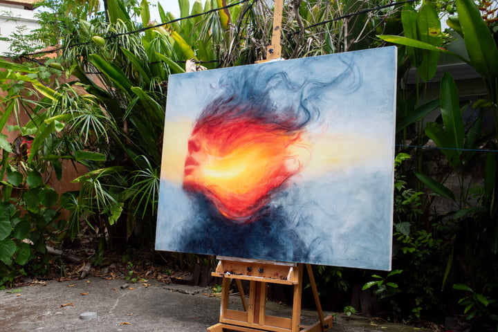 Large oil on canvas painting by Dan Bullock, titled Reverie. A dreamlike portrait of a female face in profile, dissolving into swirling colours of fiery red, orange, and golden yellow, contrasted with cool blue and smoky black tones. The composition radiates energy and motion, blending realism with abstraction.
