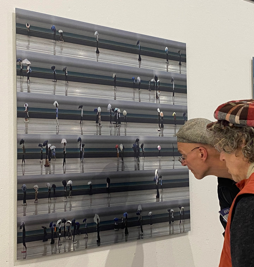 Richard P Jones Tokyo Summer Storm #1 fine art photographic print showing rows of commuters walking with umbrellas during heavy rain in Tokyo, created from reconstructed high-speed video imagery and printed as a giclée on brushed aluminium.