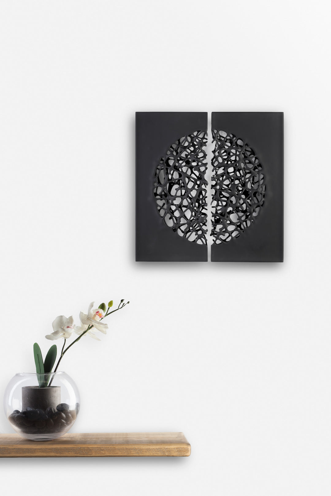 Tracy Nicholls glass wall sculpture Riven — a one-off artwork of two black glass panels forming an orb when placed side by side. The intricate webbed structure undulates with organic movement, featuring a satin-smooth exterior contrasting with a glossy black inner surface that glimmers through the open lace-like forms.