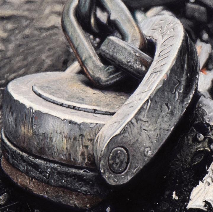 Pastel artwork depicting a heavy-duty metal security ring and chain embedded in a London street, partially torn from the tarmac and surrounded by grit, debris and cigarette ends, with sharply rendered metal textures, abrasion and grime contrasted against a softly blurred urban background to create depth and focus.