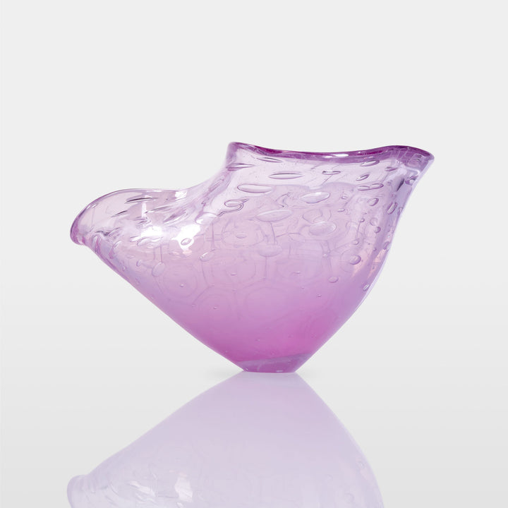 Delicately shaped lilac glass vessel with an organic rim and embossed bubble-like texture, set against a white background with soft reflection.