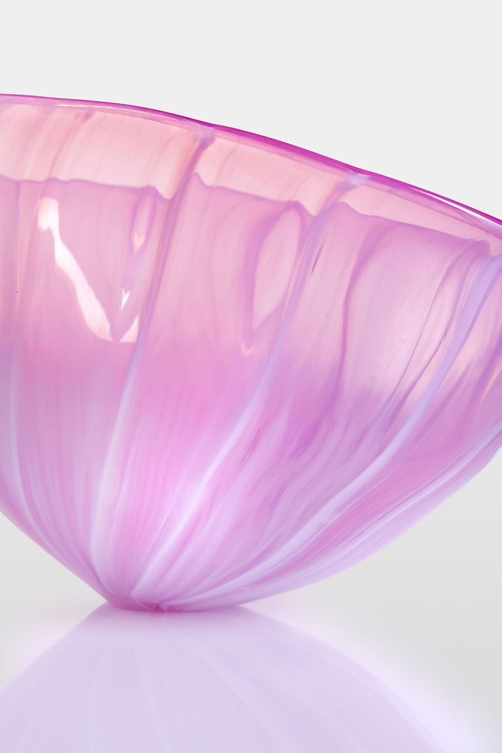 Delicately sculpted blown glass bowl in soft lilac and pink tones, with fluid contours and a translucent finish, displayed against a clean white background.