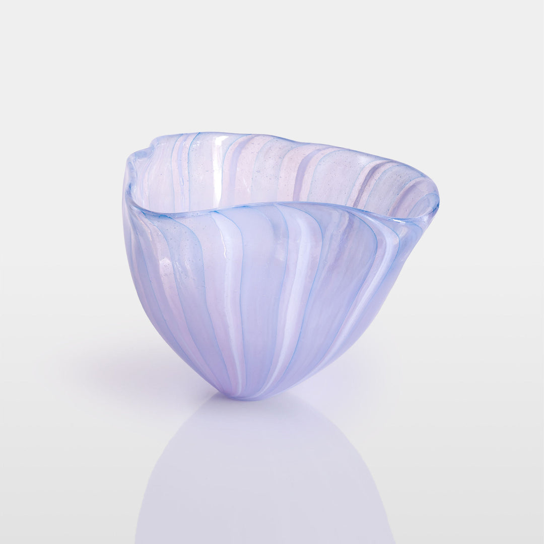 Abstract glass sculpture composed of layered, translucent panels in vivid hues—featuring crisp primary red, vibrant blue, and bright yellow alongside subtle accents of green and purple—set on a sleek black base that accentuates the interplay of light and shadow.