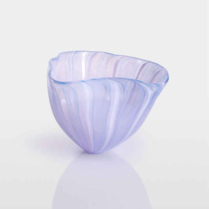 Abstract glass sculpture composed of layered, translucent panels in vivid hues—featuring crisp primary red, vibrant blue, and bright yellow alongside subtle accents of green and purple—set on a sleek black base that accentuates the interplay of light and shadow.