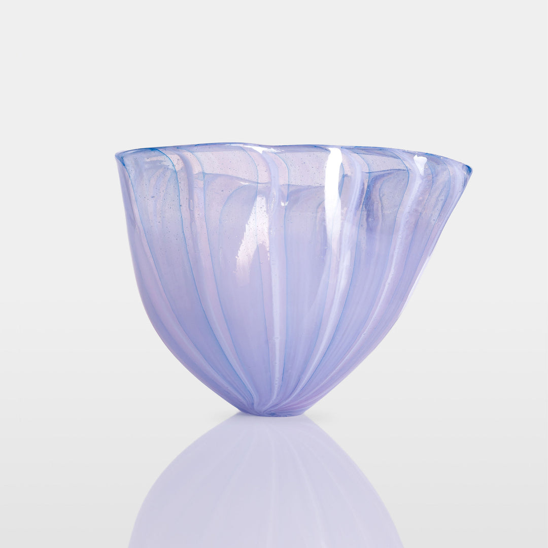 Abstract glass sculpture composed of layered, translucent panels in vivid hues—featuring crisp primary red, vibrant blue, and bright yellow alongside subtle accents of green and purple—set on a sleek black base that accentuates the interplay of light and shadow.