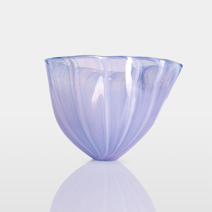 Abstract glass sculpture composed of layered, translucent panels in vivid hues—featuring crisp primary red, vibrant blue, and bright yellow alongside subtle accents of green and purple—set on a sleek black base that accentuates the interplay of light and shadow.