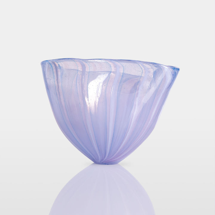 Abstract glass sculpture composed of layered, translucent panels in vivid hues—featuring crisp primary red, vibrant blue, and bright yellow alongside subtle accents of green and purple—set on a sleek black base that accentuates the interplay of light and shadow.