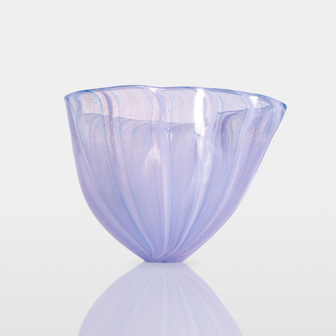 Abstract glass sculpture composed of layered, translucent panels in vivid hues—featuring crisp primary red, vibrant blue, and bright yellow alongside subtle accents of green and purple—set on a sleek black base that accentuates the interplay of light and shadow.