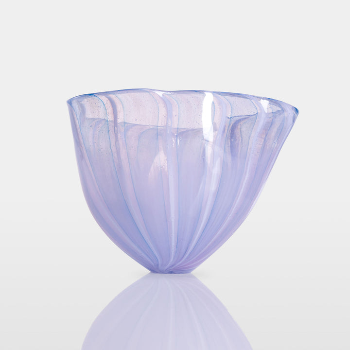 Abstract glass sculpture composed of layered, translucent panels in vivid hues—featuring crisp primary red, vibrant blue, and bright yellow alongside subtle accents of green and purple—set on a sleek black base that accentuates the interplay of light and shadow.