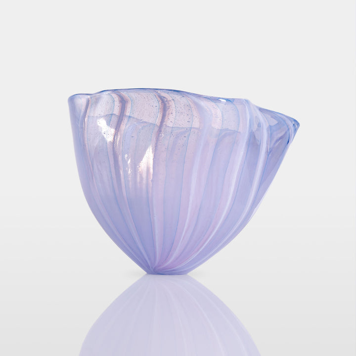 Abstract glass sculpture composed of layered, translucent panels in vivid hues—featuring crisp primary red, vibrant blue, and bright yellow alongside subtle accents of green and purple—set on a sleek black base that accentuates the interplay of light and shadow.