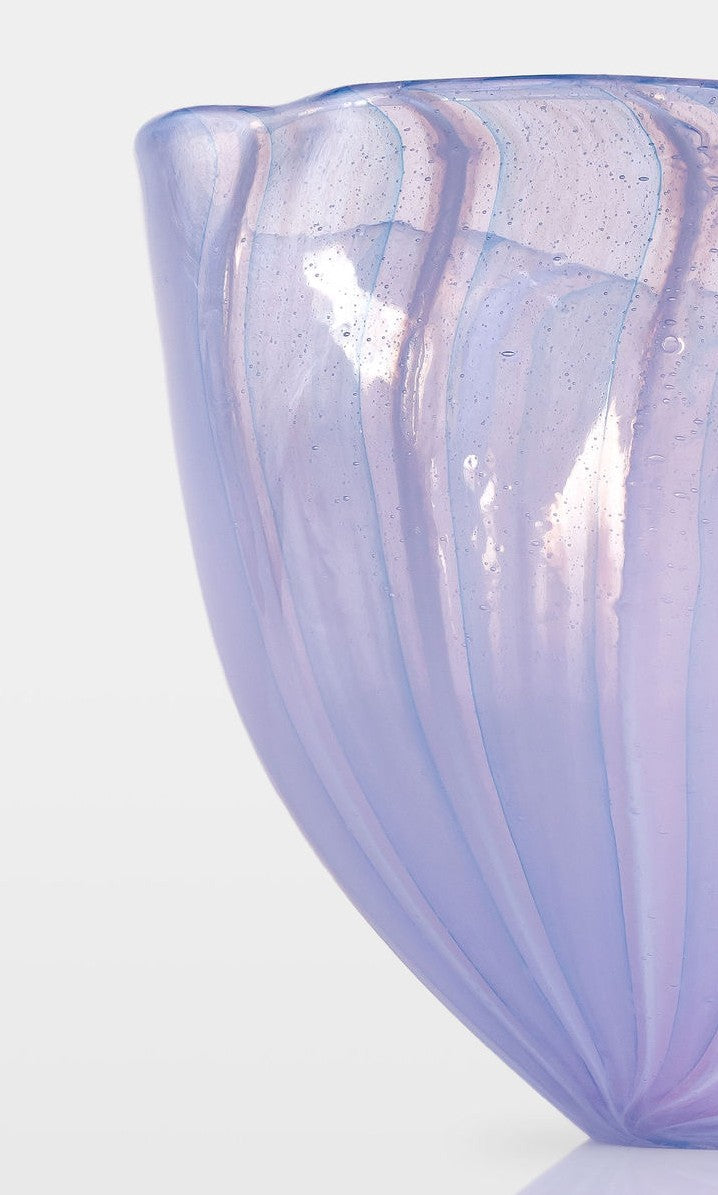 Abstract glass sculpture composed of layered, translucent panels in vivid hues—featuring crisp primary red, vibrant blue, and bright yellow alongside subtle accents of green and purple—set on a sleek black base that accentuates the interplay of light and shadow.