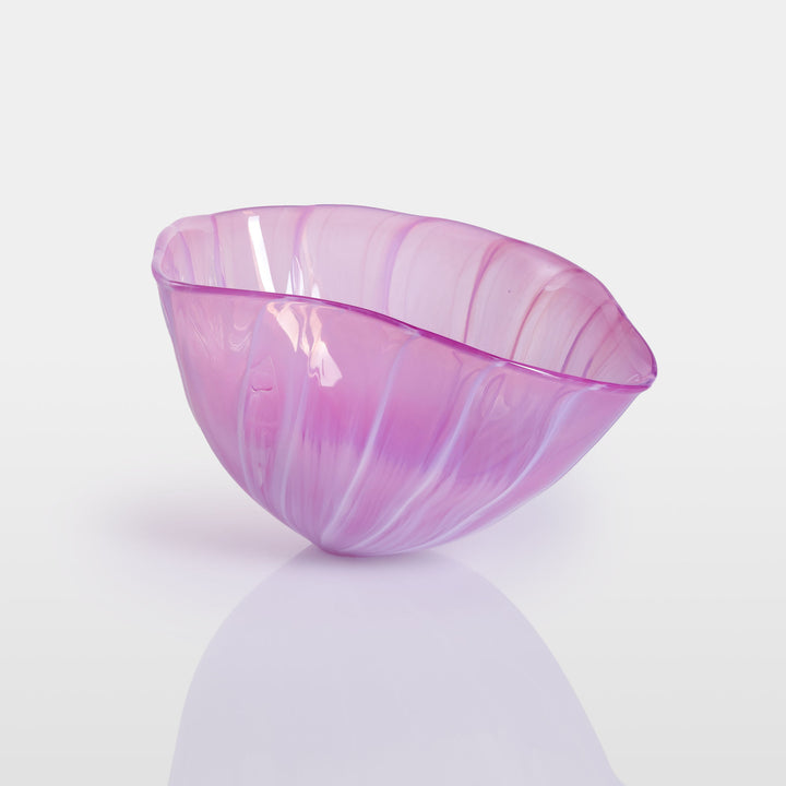 Delicately sculpted blown glass bowl in soft lilac and pink tones, with fluid contours and a translucent finish, displayed against a clean white background.